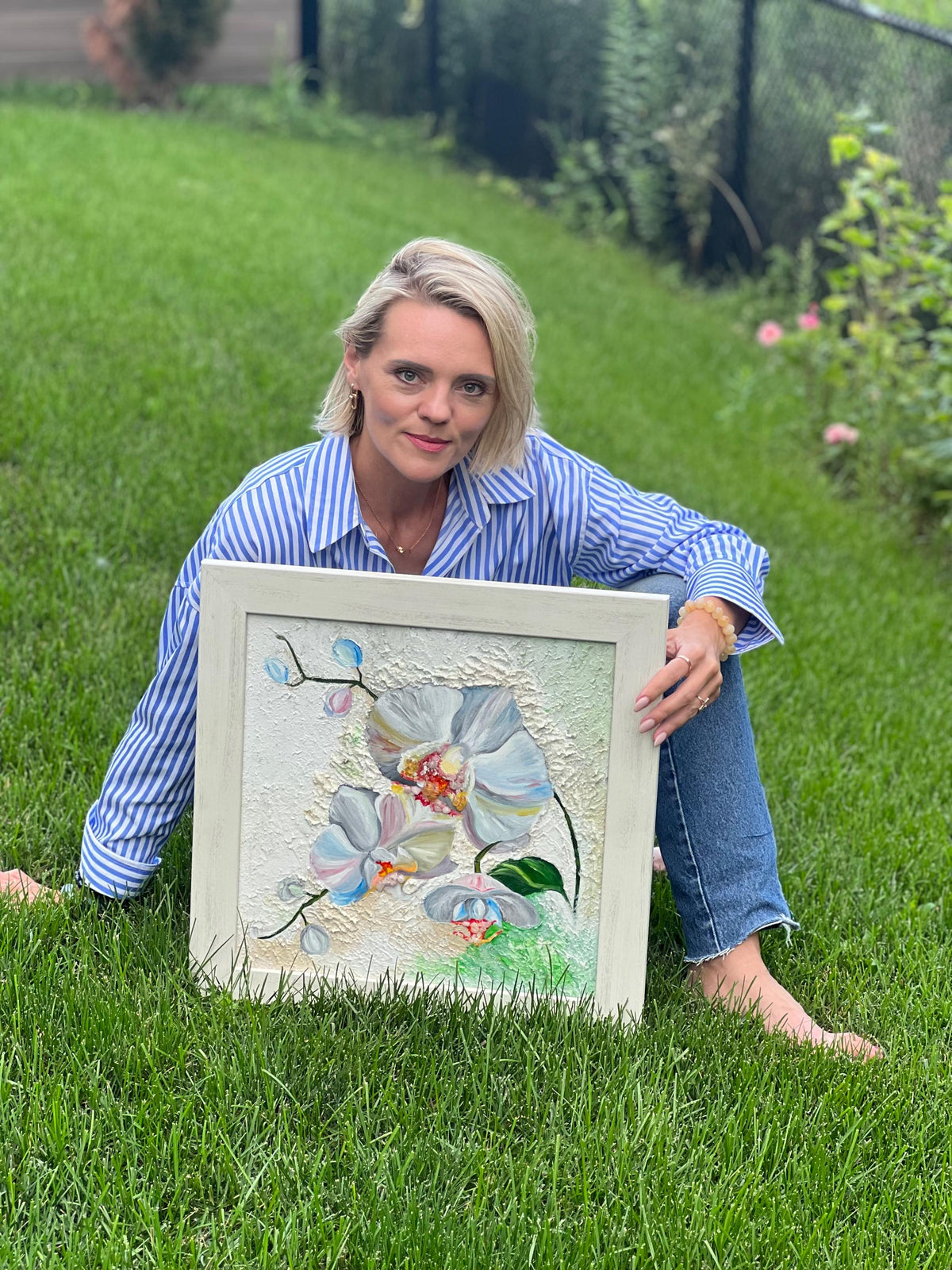 Artist holding White Orchid with Citrine outdoors