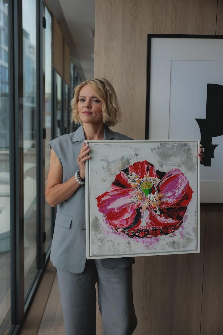 Artist holding Red Poppy, an original acrylic painting