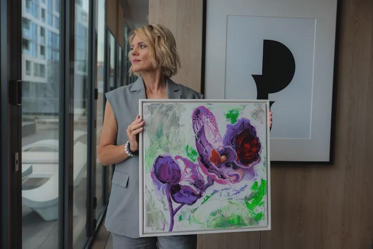Artist holding Purple Orchid, an original acrylic painting